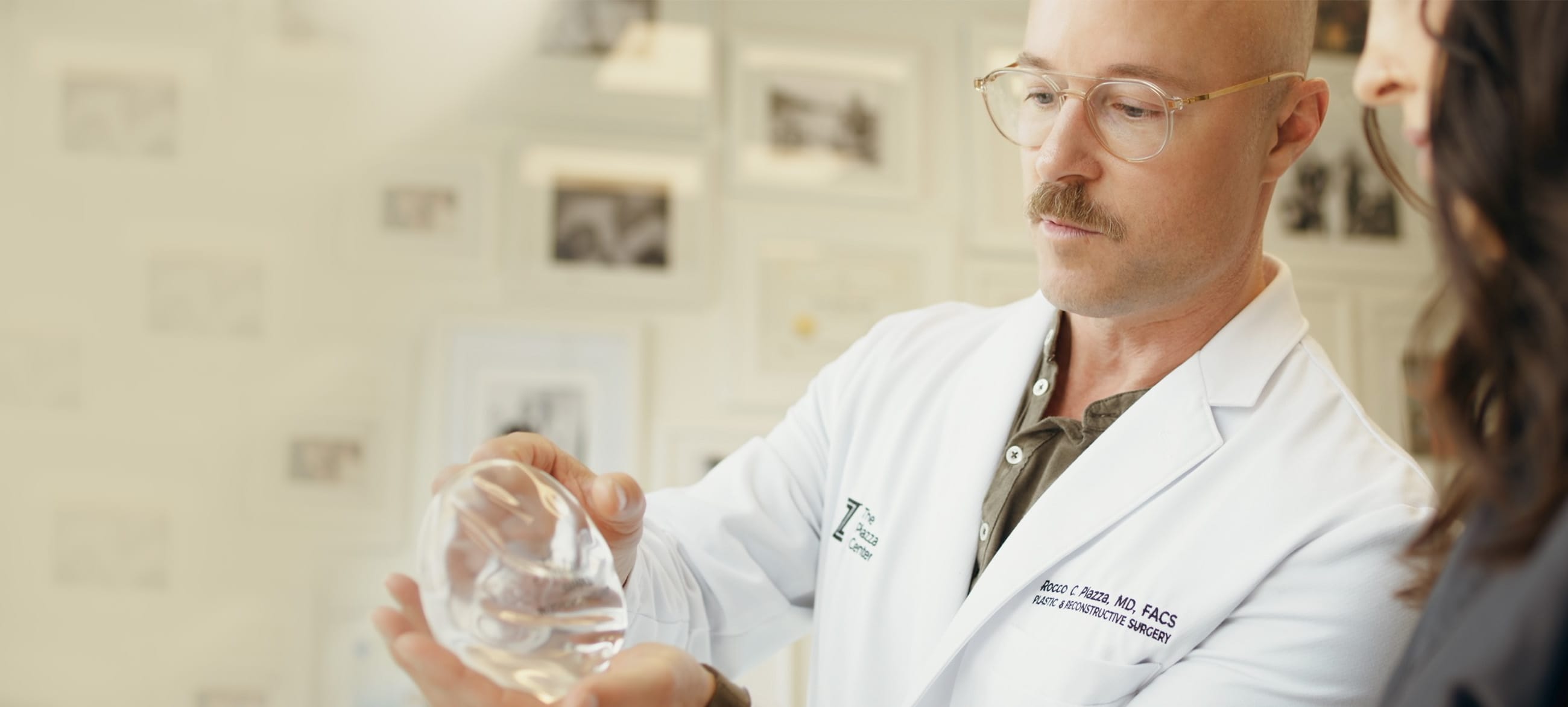 Dr. Piazza examining a Motiva implant with a patient